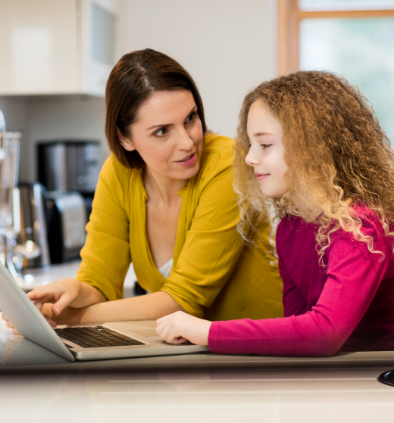 mother-daughter-using-laptop-kitchen